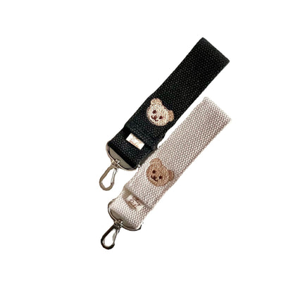 Two strap ends with teddy bear designs on a white background