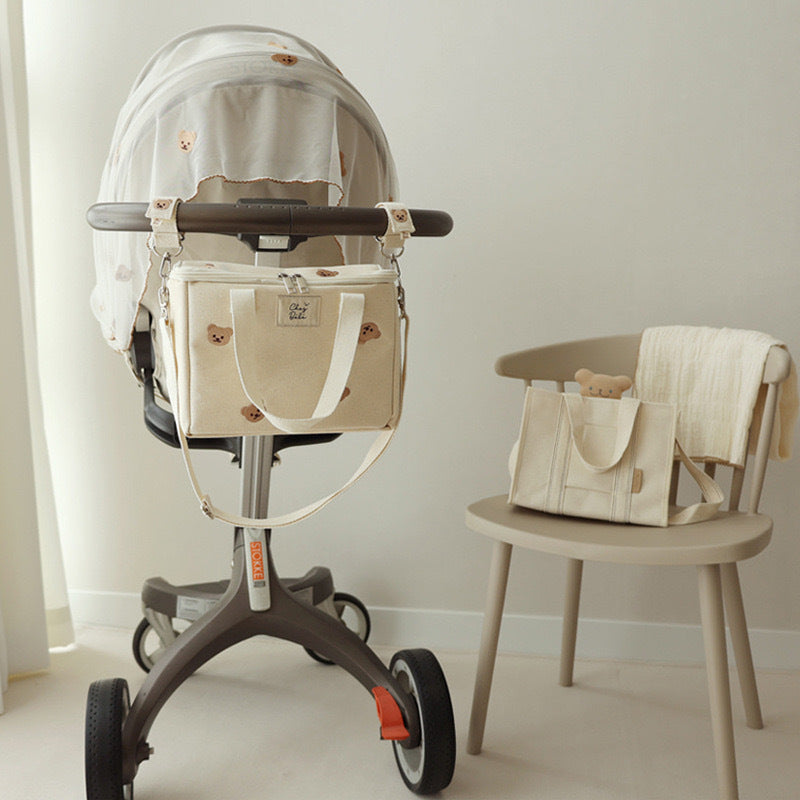 Baby stroller with matching bag and high chair in a minimalistic setting