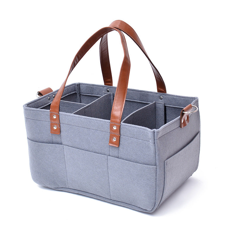 Felt storage bag demonstrating spacious interior for diapers and baby supplies