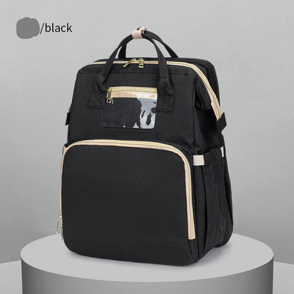 Black backpack with gold accents on a gray background
