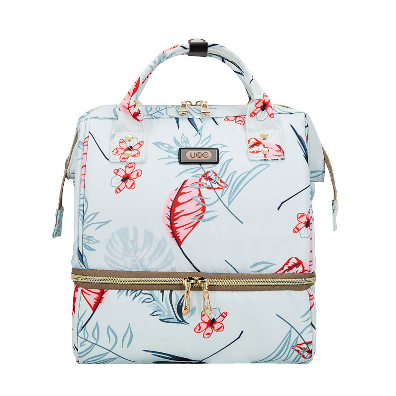 Floral-patterned backpack with gold zipper on a white background