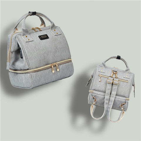 Gray backpack with gold zippers on a light gray background