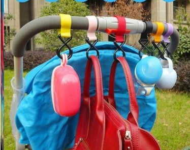 Multi-colored umbrella holder with various umbrellas and bags attached outdoors.