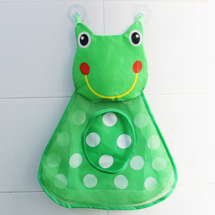 Green frog-shaped mesh bag with polka dots on a white tiled wall background