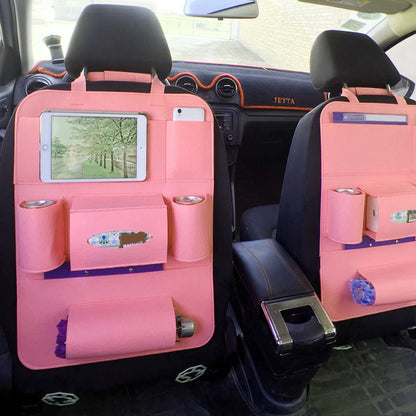 Pink car seat organizers with pockets and a tablet holder inside a vehicle.