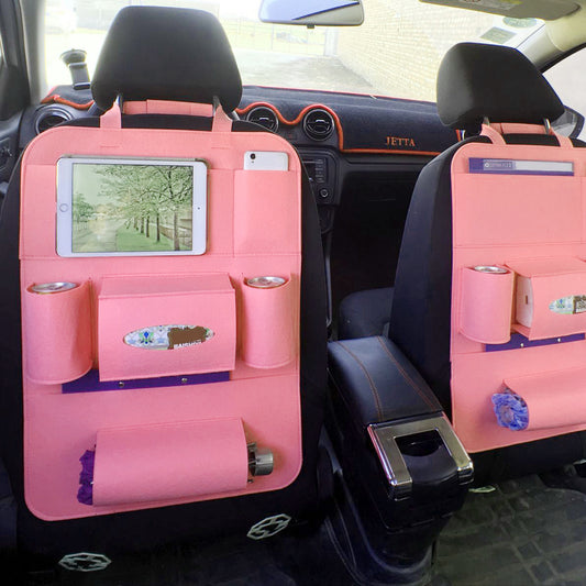Pink car seat organizers with pockets and a tablet holder inside a vehicle.