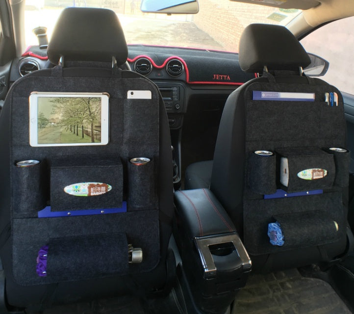 Car interior with black seat covers and storage compartments.
