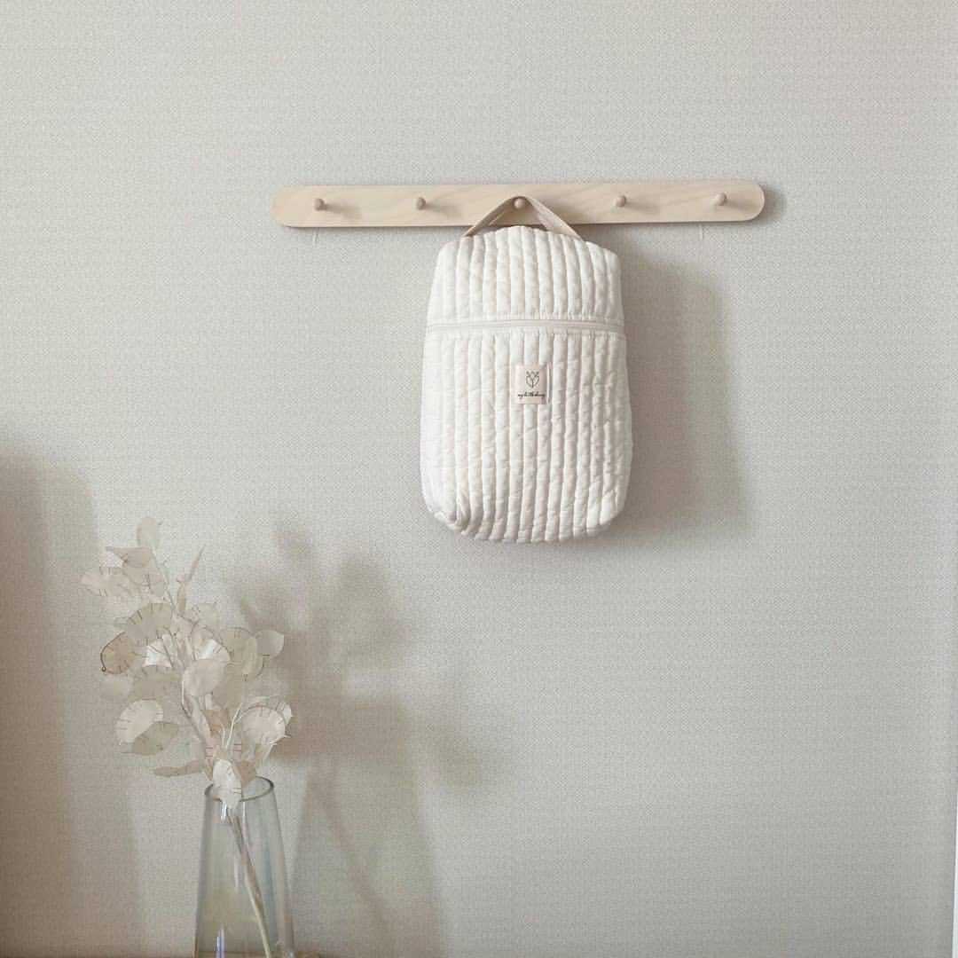 Diaper storage bag showing versatile use for nursery organization and outings